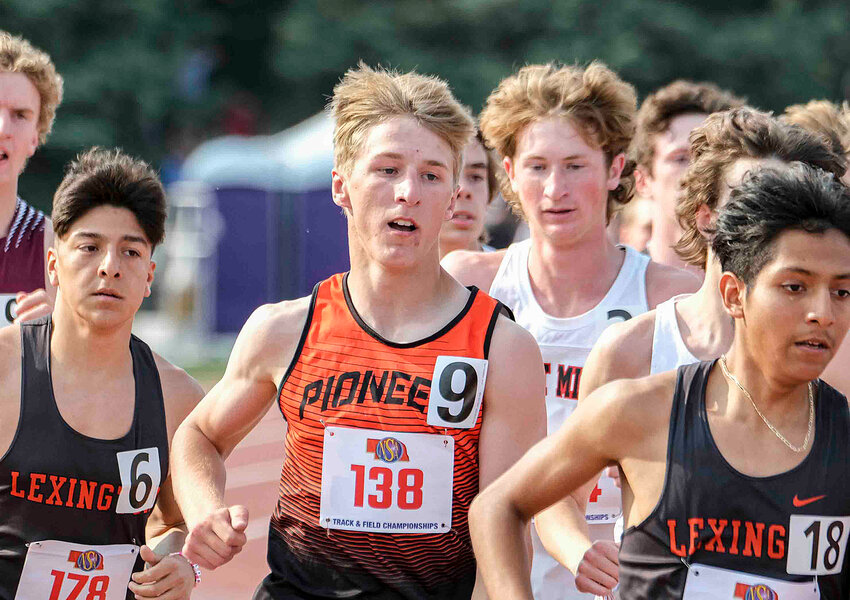 Fort Calhoun senior Ely Olberding, middle, runs the 3,200-meter relay Wednesday during the NSAA State Championships at Omaha Burke Stadium.