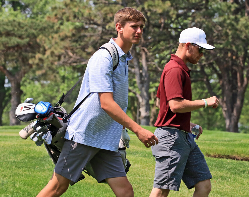 Arlington golfer Eddie Rosenthal, left, and his coach, Landon Walkenhorst, walk to the Eagle's ball in the fairway May 24 in Columbus.