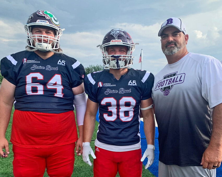 Bears Seagan Packett-Trisdale, left, and Dane Larsen, middle, pose for a photo with Blair High School football coach Bryan Soukup on Saturday during the Shrine Bowl in Kearney.