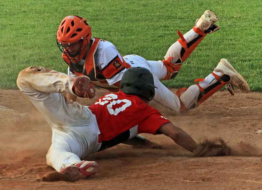 Zig Drywall Senior Legion catcher Chase Premer, top, attempts to tag out a Valparaiso batter at home plate Tuesday in Fort Calhoun.