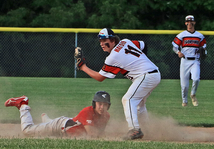 The Pioneers' Sam Halford, middle, and a Valparaiso base runner look to the umpire for a call Tuesday in Fort Calhoun. Post 348's Tristan Fuhrman, right, runs in from centerfield for a closer look.