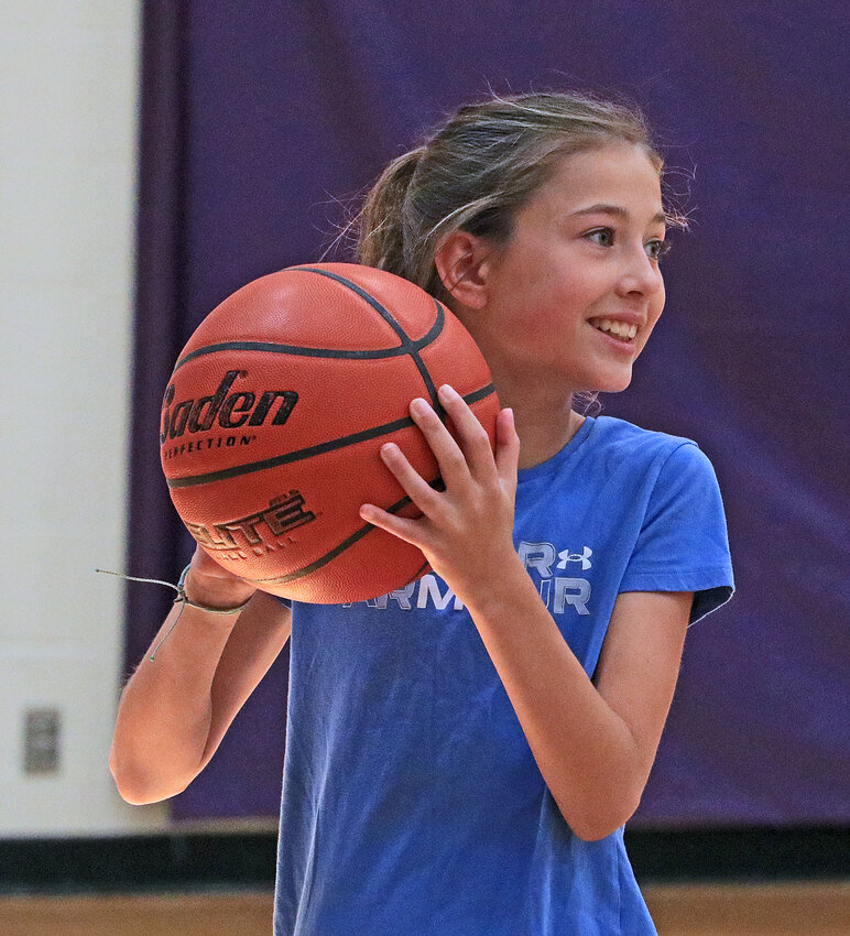 Aubrey Bonney, 10, looks over her shoulder and smiles before taking a shot Tuesday at Blair High School.