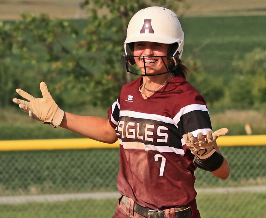 Arlington junior Britt Nielsen shrugs and smiles Friday during the first of her three home run trots at RVR Bank Sports Complex.