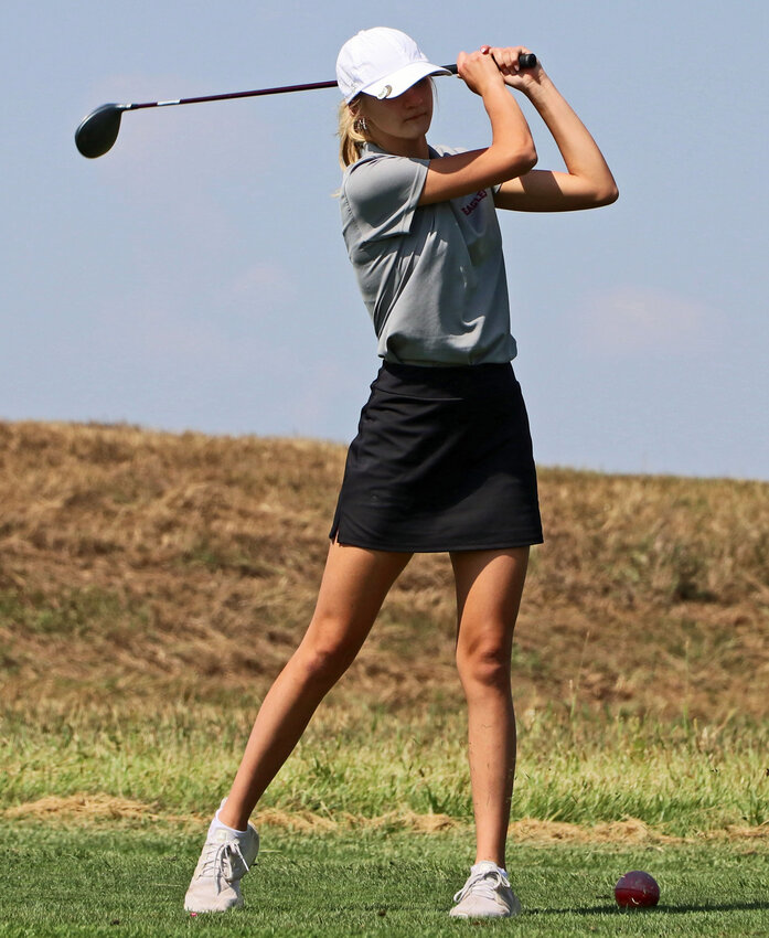The Arlington Eagles' Ally Meyer tees off Tuesday at River Wilds Golf Club.