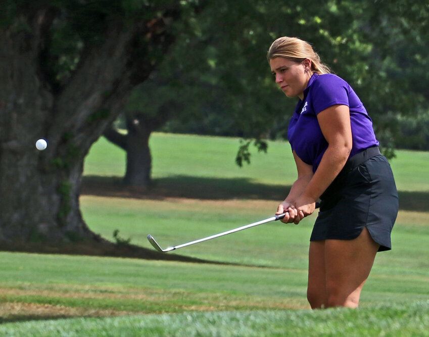 The Blair Bears' Wrylee Osterhaus chips onto the seventh green Monday at River Wilds Golf Club.