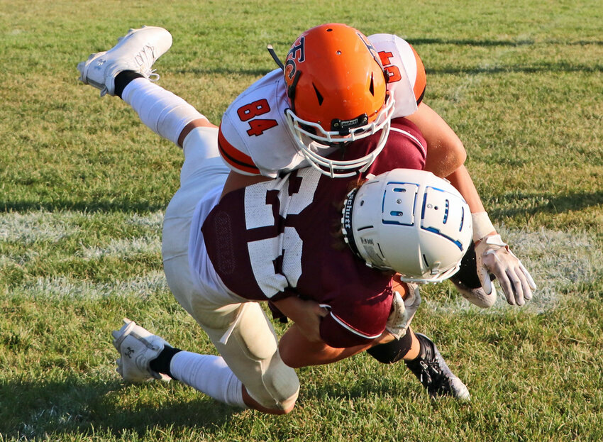 Fort Calhoun seventh-grader Carter Doyle, top, tackles the Eagles' Peyton Marfisi after a long gain the passing game Tuesday at Arlington High School.