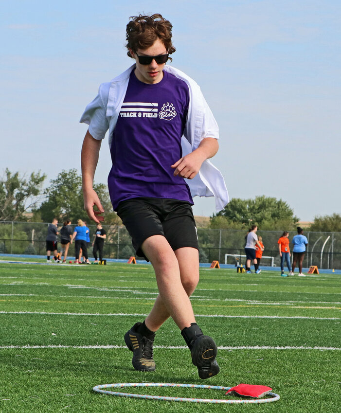 Caden Finken of Blair races to retrieve his bean bag Thursday at Bennington High School.