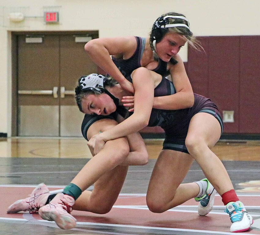 Brooklyn Ruskamp, right, attempts to take down Sofie Lewis on Nov. 21 at Arlington High School.