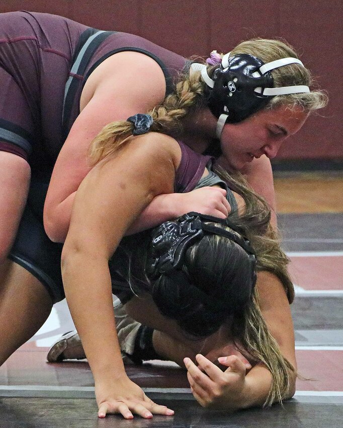 Evie Bottger, top, attempts to turn Dianna Flores to her back Nov. 21 at Arlington High School.