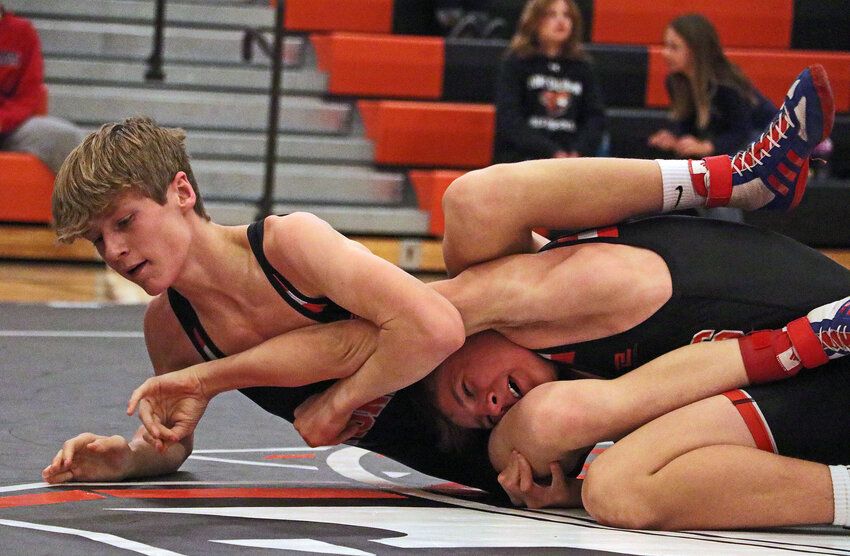 Presley Olberding, left, attempts to avoid giving up a takedown to Pioneers teammate Landon Bernasek on Tuesday during an intrasquad scrimmage at Fort Calhoun High School.