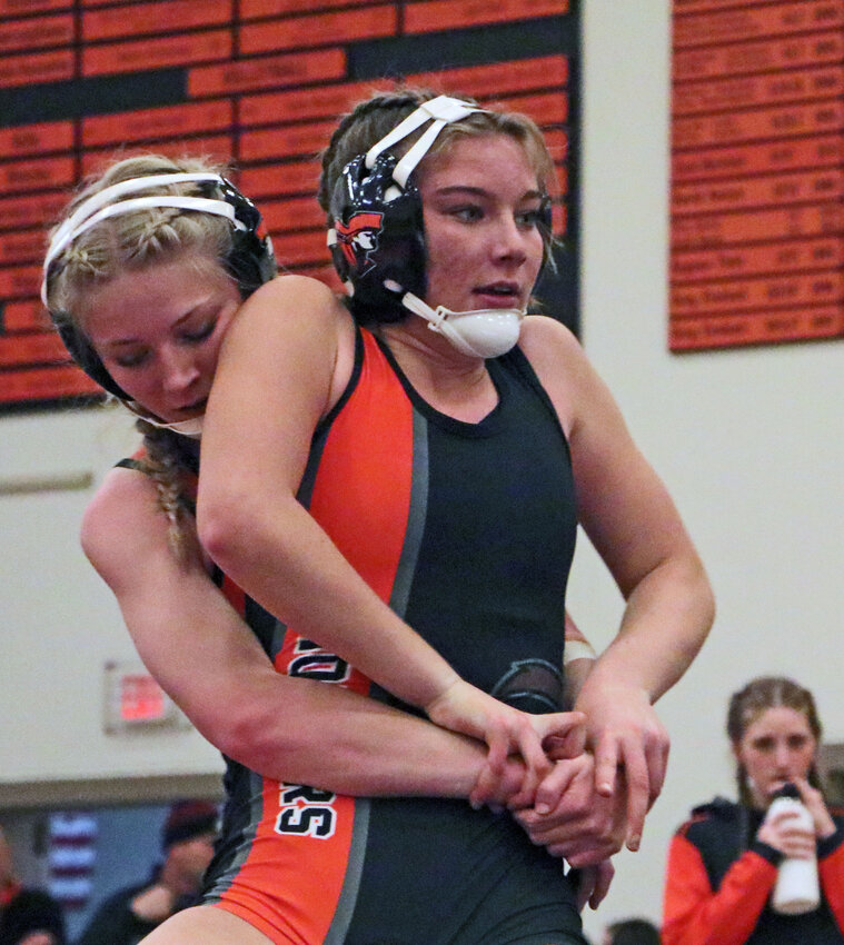 Madi Larrick, right, attempts to escape the clutches of Pioneers teammate Ali Dill on Tuesday at Fort Calhoun High School.
