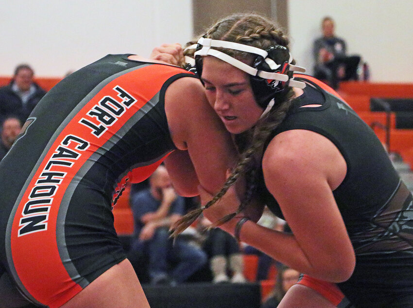 Tacey Belina, right, wrestles Pioneers teammate Anna Rae Hartline on Tuesday at Fort Calhoun High School.