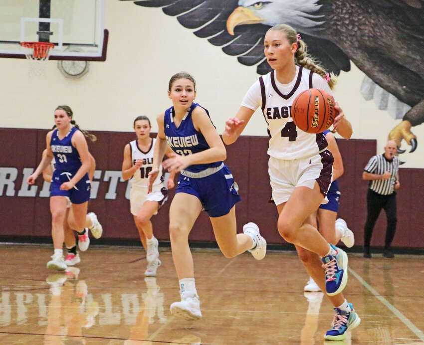 The Eagles' Macy Wolf, right, leads a fast break Saturday at Arlington High School.