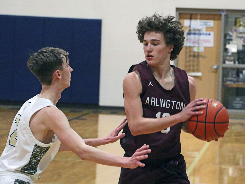 Arlington's Dallin Franzluebbers, right, keeps the ball from the Warriors on Dec. 29 at Lincoln Lutheran.