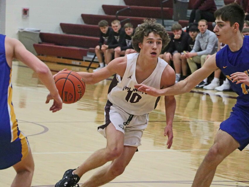 Eagles guard Dallin Franzluebbers, middle, dribbles down the lane against Logan View on Tuesday at Arlington High School.