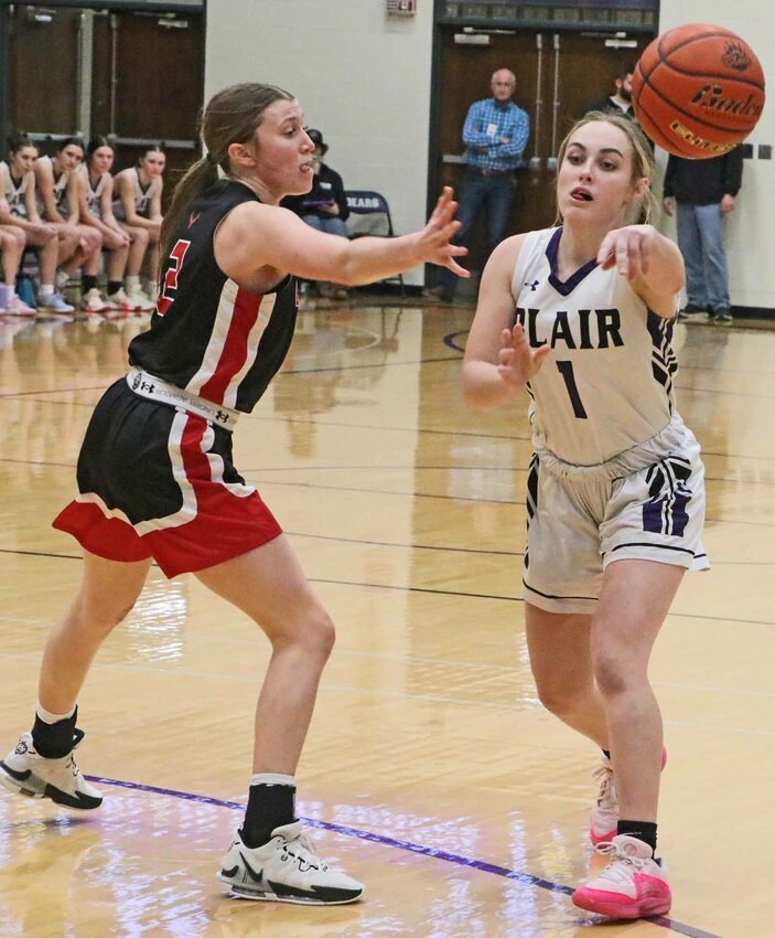 The Bears' Jacy Schueth, right, passes the ball against the Antlers on Tuesday at Blair High School.