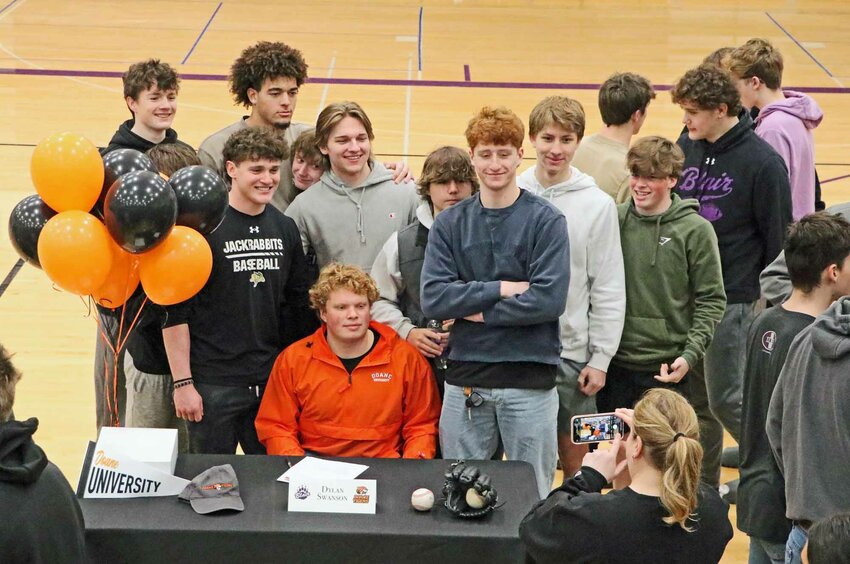 Doane Tigers signee Dylan Swanson poses for a photo with his Blair High School baseball teammates Wednesday morning.