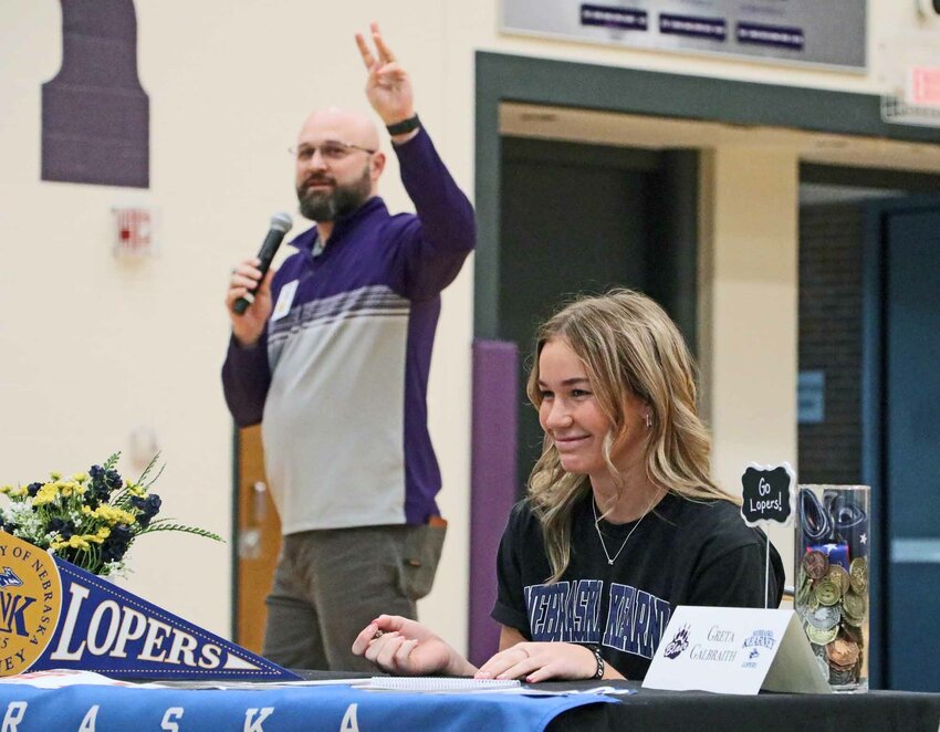 Greta Galbraith gets ready to sign with the UNK Lopers track team as Blair Activities Director Tyler Siecke counts her and her classmates down Wednesday morning.