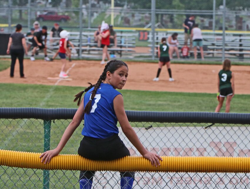 Rose Borges of the Edward Jones team sits on the bullpen fence Tuesday during the Blair Youth Softball Association Modifieds Tournament. After rain emptied the park Monday, both Blair Little League and the BYSA filled all but one of the fields at the Blair Youth Sprots Complex on Tuesday. Tourney championship games were scheduled for later in the week with results set to appear in next Tuesday's Washington County Pilot-Tribune edition.