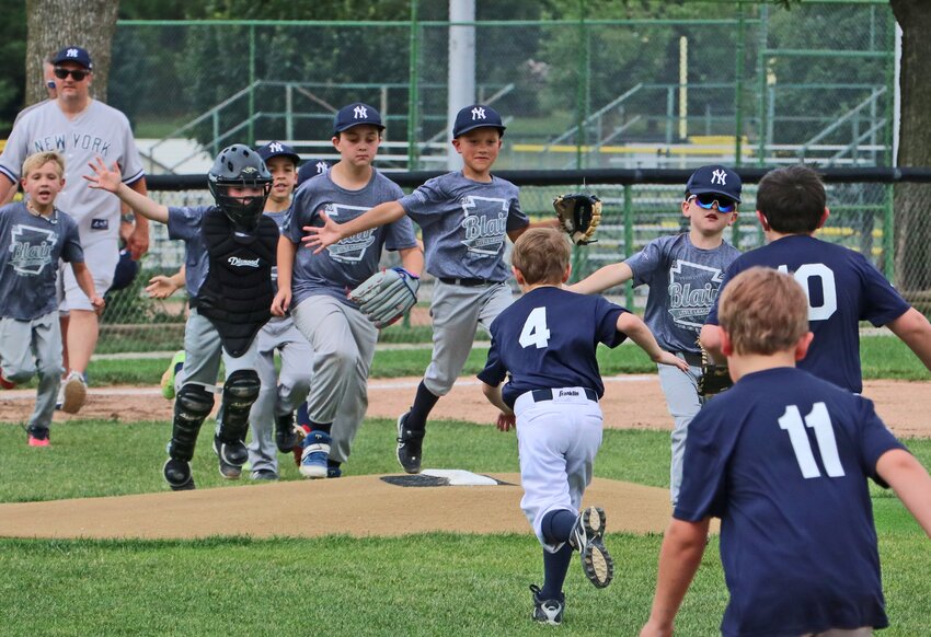 The Blair Little League Yankees, left, and Guardians shake hands after a Rookies League game Tuesday at the Youth Sports Complex.