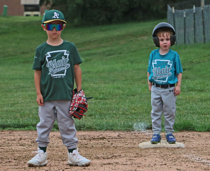 Blair Little Leaguers Hudson Wacker, left, and Wyatt Dawson wait for the action to begin again at first base Tuesday at the Youth Sports Complex.