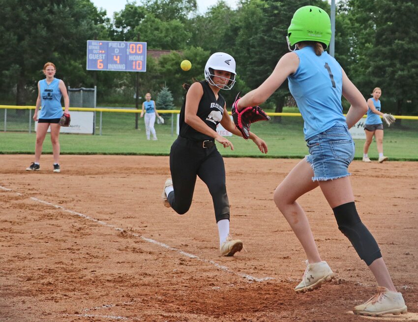 Isabella Borges of Black Bison Contracting, left, races toward home plate as AJ's Service & Repair's Taylor Beister, right, waits on the throw Tuesday at the Youth Sports Complex.