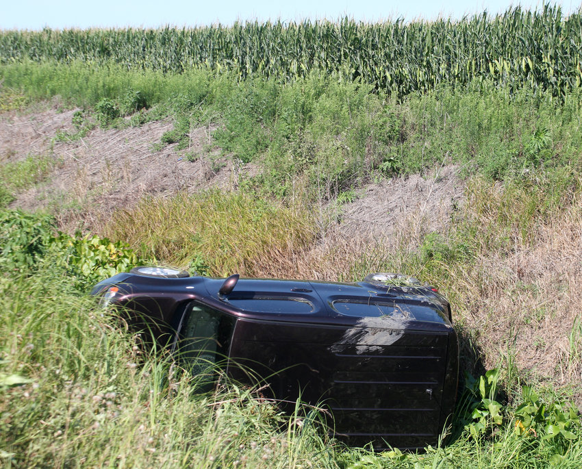 A Nissan Cube lays on its side in a steep ditch following a one-vehicle accident along County Road P31 north of Blair. Two people were uninjured in the crash.
