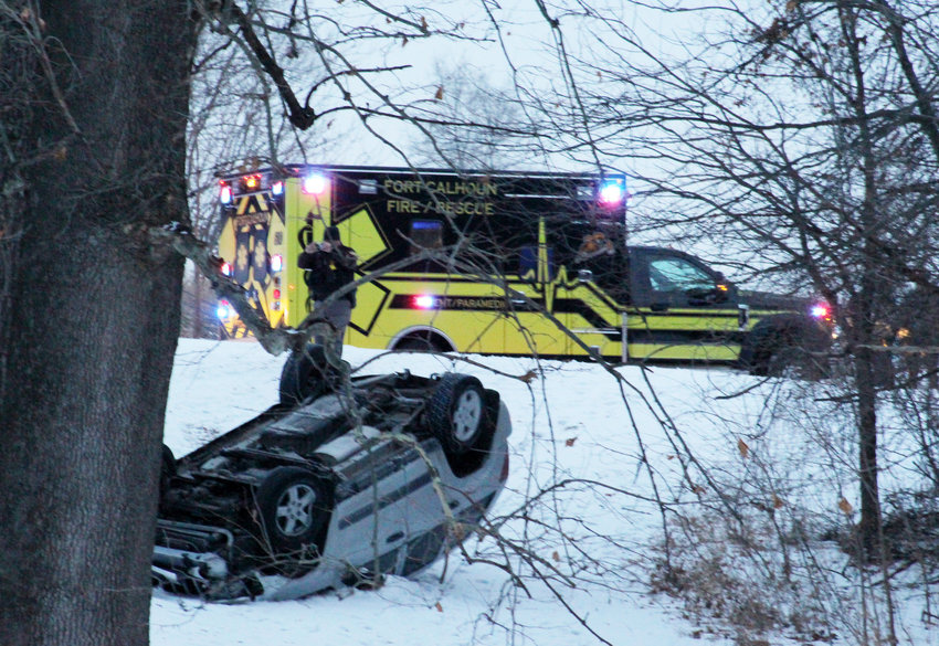 Deputy Shawn Thallas takes photos of an overturned Jeep after an accident Tuesday in West Market Square Park in Fort Calhoun. Fort Calhoun Rescue responded to the crash. The driver as uninjured.