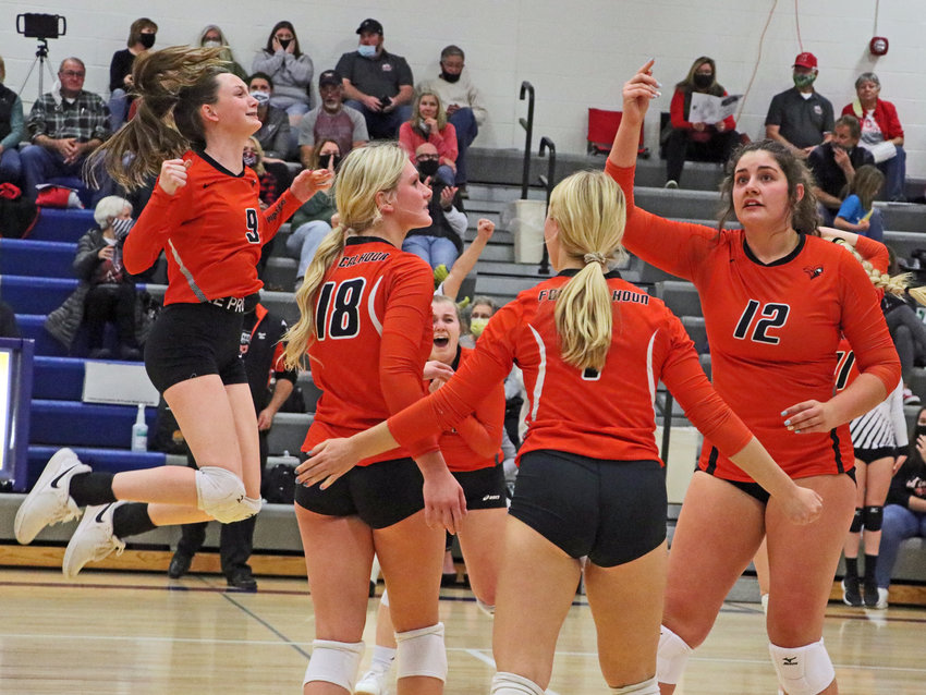The Fort Calhoun volleyball team &mdash; Grace Genoways, from left, Ellie Lienemann, Kaitlin Smith and Alivia Cullen &mdash; react to the final point of their match win against Omaha Concordia on Monday at Wahoo High School.