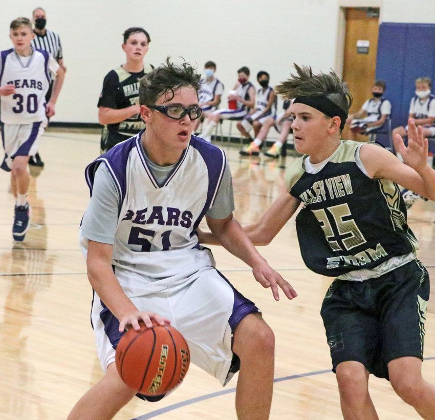 Bears eighth-grader Thomas Chikos dribbles the ball to the hoop as Elkhorn Valley View's Isaac Kulig defends Monday at Otte Blair Middle School.