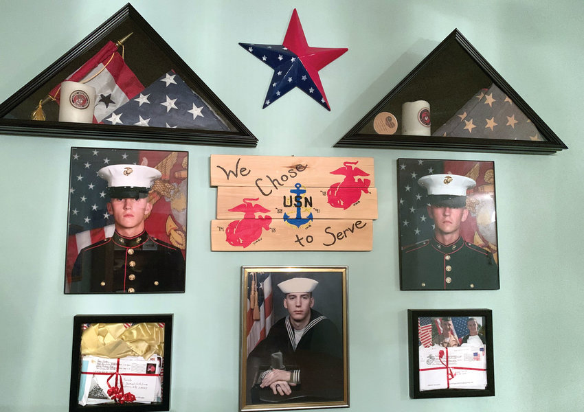 From left, a wall in the Bolen home displays CJ, Clayton and Hunter Bolen in their respective military uniforms. CJ graduated from Fort Calhoun High School in 2013, Clayton in 1988 and Hunter in 2018..