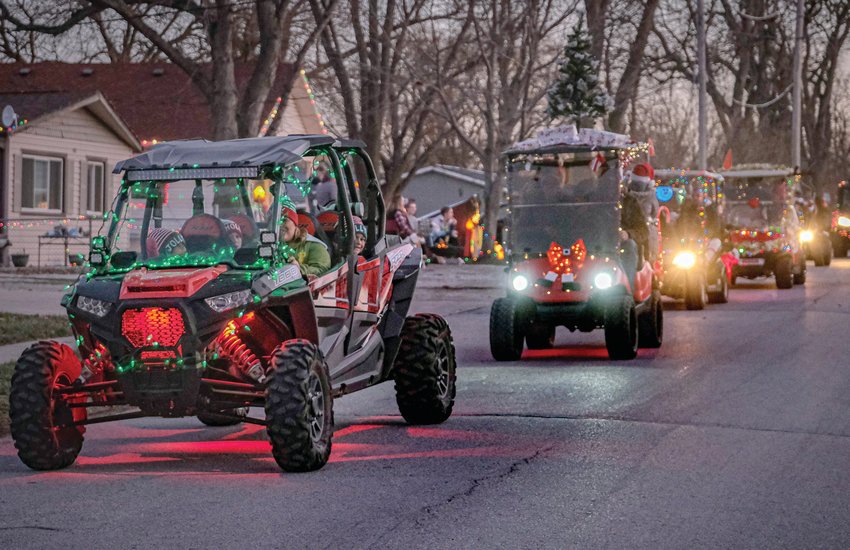 Brightly lit and decorated ATVs and golf carts parade along 10th street in Fort Calhoun on Saturday during the Christmas Parade of Lights.