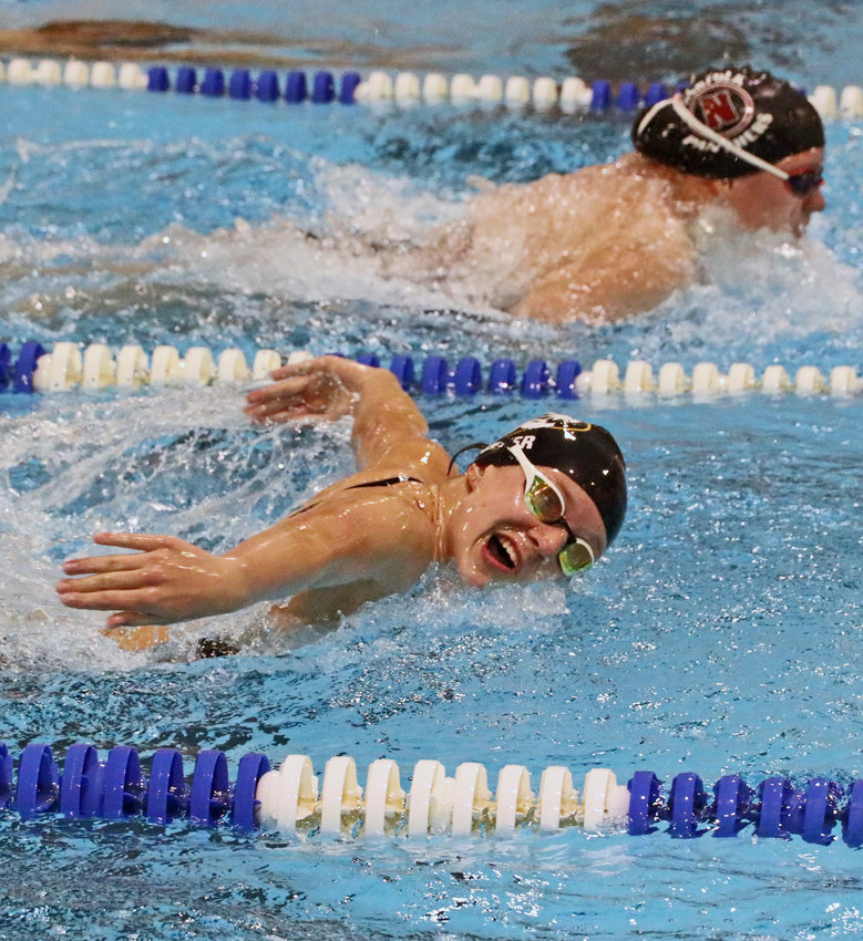 Arlington freshman Elisabeth Meyer, foreground, swims for the Fremont Tigers on Tuesday at the Fremont Family YMCA.