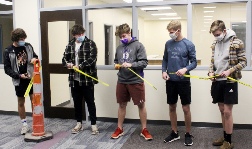 Blair High School students Riley Camelin, TJ Swaney, Morgan Rump, Ben Hagedorn and Zach Kern cut the caution tape to mark the completion of the new BHS office that they helped design.
