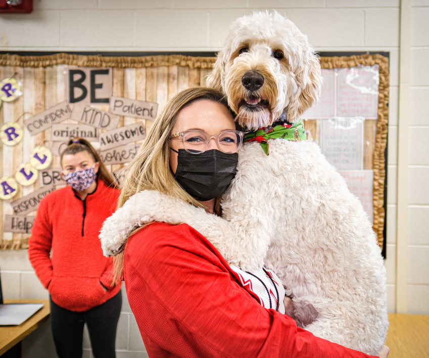 Special education teacher Monica Maly holds her 2-year-old goldendoodle Ted, who serves as a therapy dog at Blair High School.