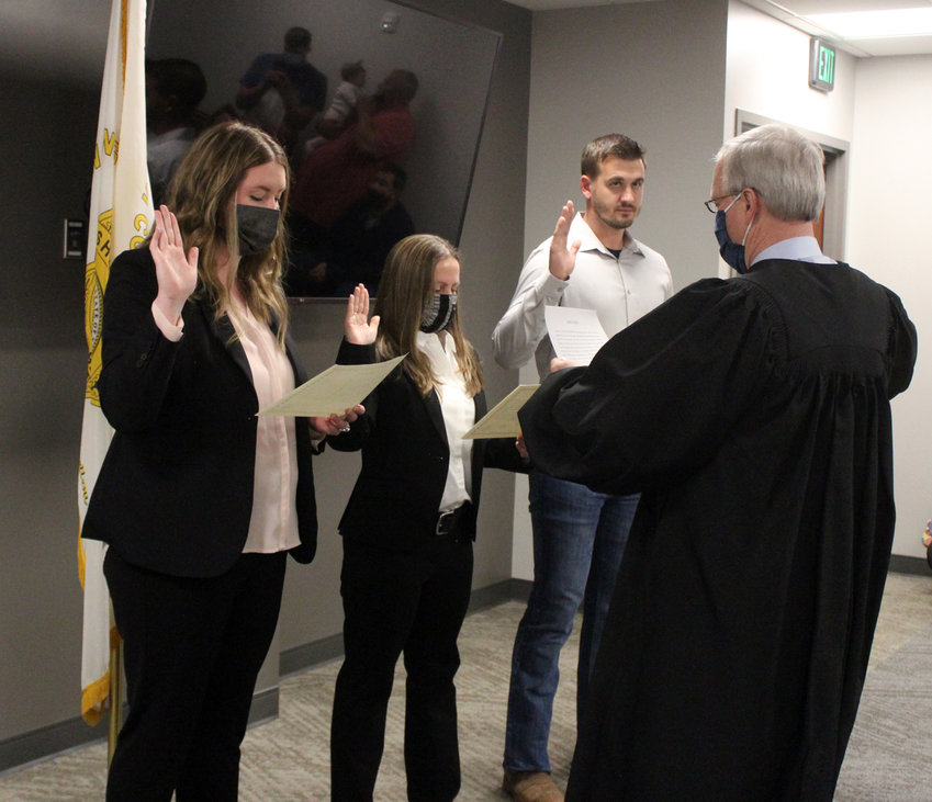 From left, Jessica Penry, Andrea Murphy, both full-time, and James Hetzler, part-time, are sworn in as Washington County Sheriff's Office deputies by Judge John E. Samson Tuesday evening.
