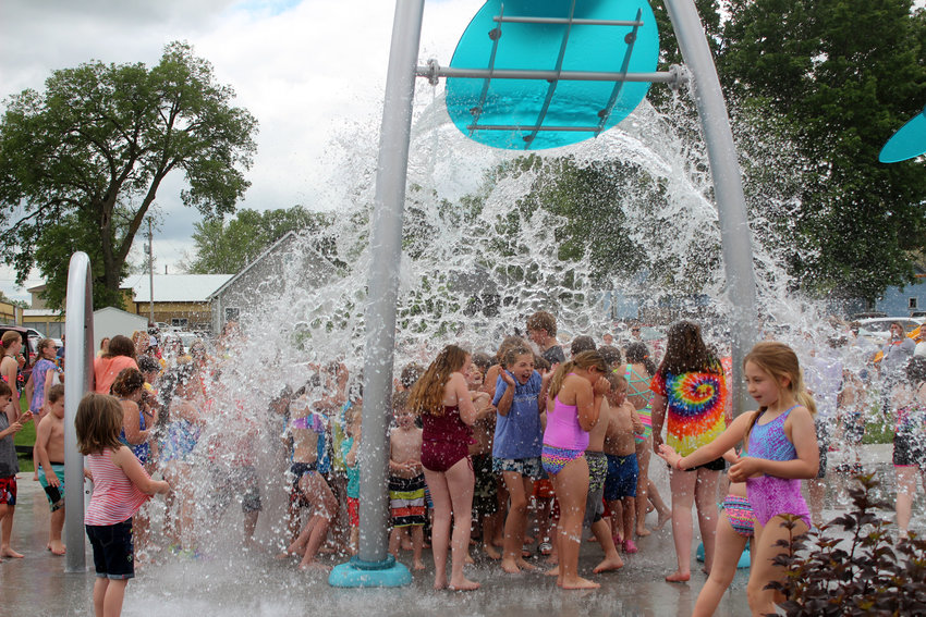 The Adams Street Corridor Splash Pad in Fort Calhoun opened Friday afternoon with a ribbon cutting ceremony. Included at the splash pad is a bucket faucet, which fills up with water before dunking it out on those standing underneath.