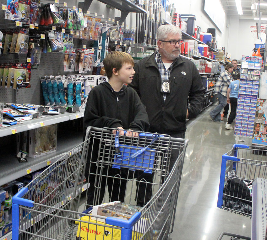 Seth Wiess shops with Blair Detective Russ Cook Tuesday at Walmart during Shop with a Cop.