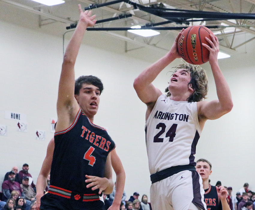 Eagles senior Nick Smith, right, rises up for a shot over North Bend Central's Jordan Ondracek on Tuesday at Arlington High School.