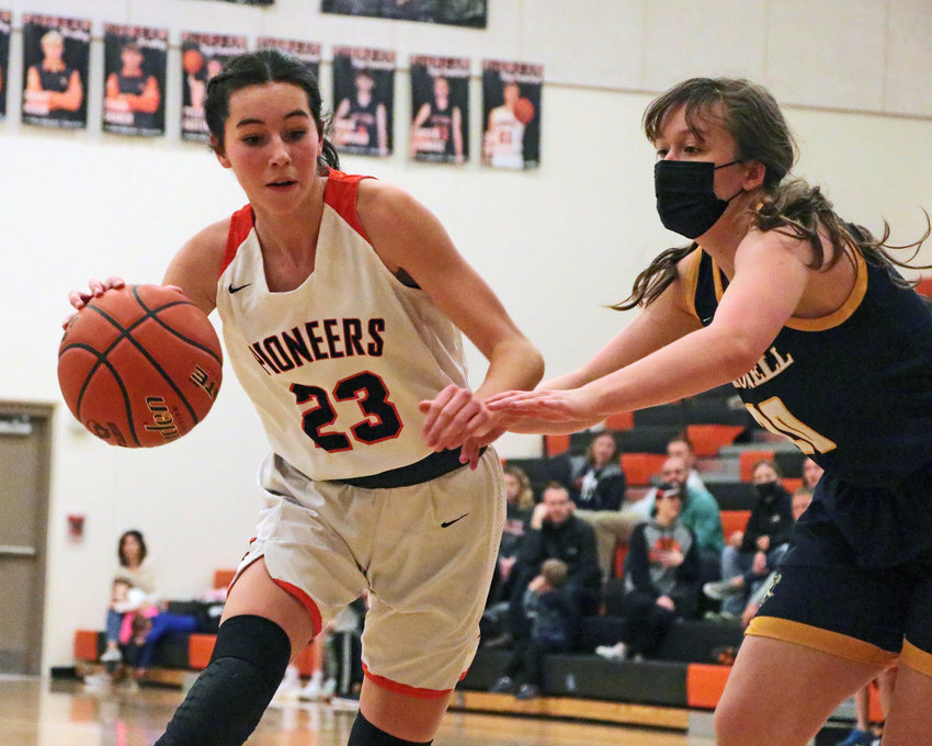 Pioneers forward Bria Bench, left, dribbles by Brownell-Talbot's Molly Clark on Tuesday at Fort Calhoun High School.