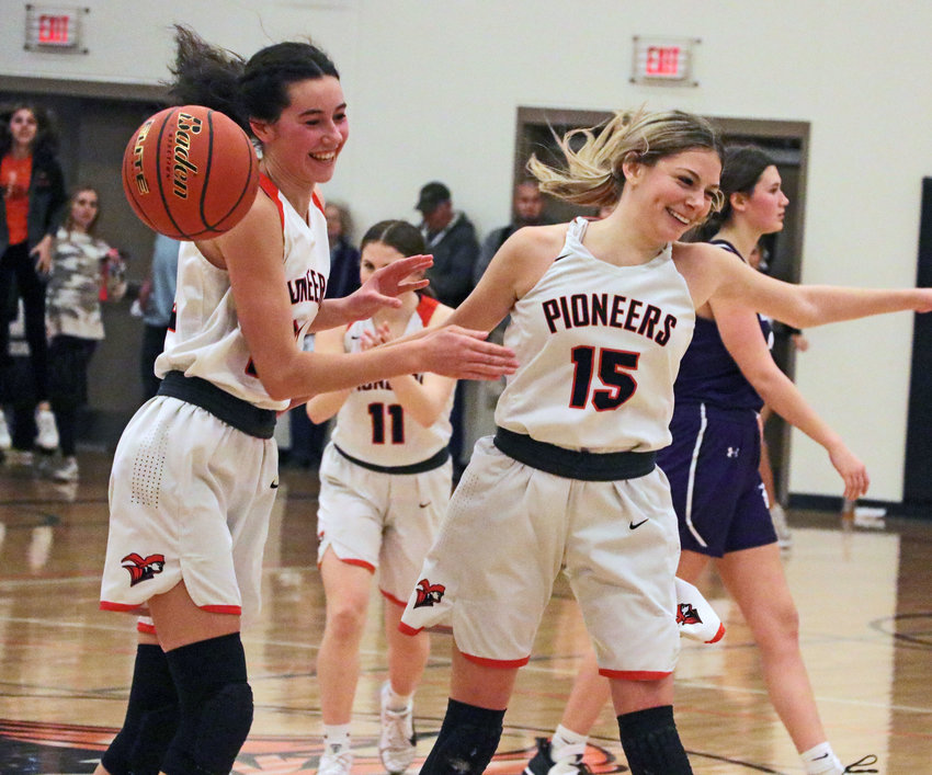 Pioneers Bria Bench, left, and Tess Skelton celebrate a 34-32 win over Nebraska City on Tuesday at Fort Calhoun High School.