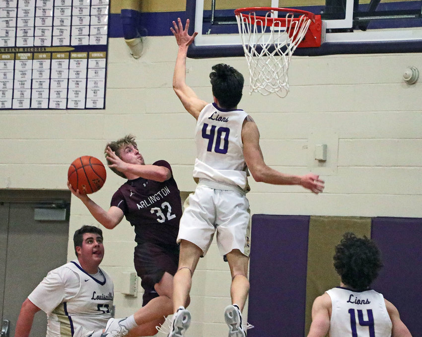 Arlington senior Isaac Foust, second from left, puts up an inside shot as the Lions' Harrison Klein, middle right, tries to block it Friday at Louisville High School.