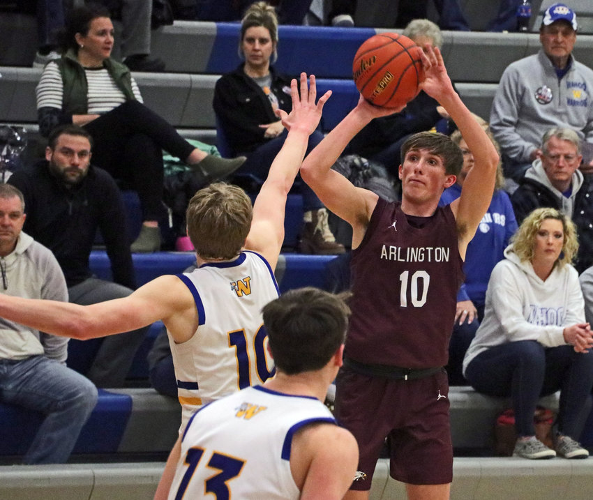 Arlington senior Colby Grefe, right, fires a 3-point shot Tuesday during the Class C1-4 Subdistrict Tournament at Wahoo High School.