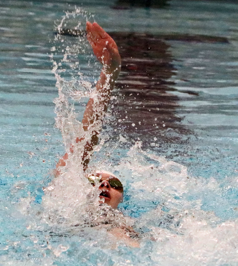 Blair freshman Jane Busboom of the Fremont Tigers competes in the 100-yard backstroke Friday during the NSAA State Swimming &amp; Diving Championships in Lincoln.