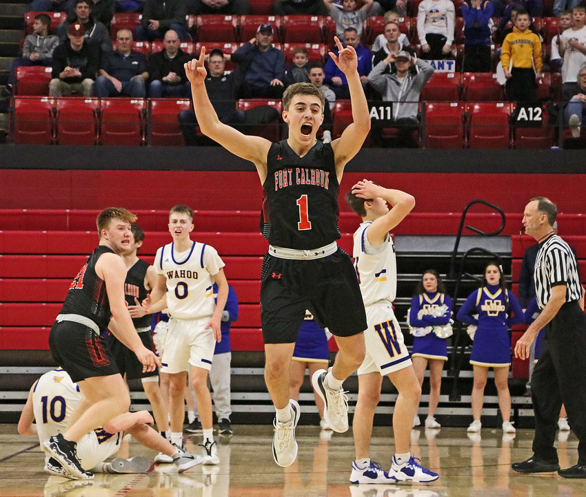 Fort Calhoun junior Austin Welchert, middle, celebrates at the conclusion of the Pioneers' first-round state tournament win over Wahoo on Tuesday at the Bob Devaney Sports Center in Lincoln.