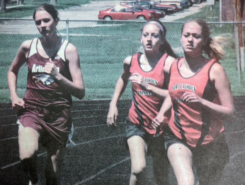 Arlington distance runner Caroline Jamison, left, races against Kristin Cherko, middle, and Chrissy Schroeder of Fort Calhoun during the 2007 Nebraska Capitol Conference meet.