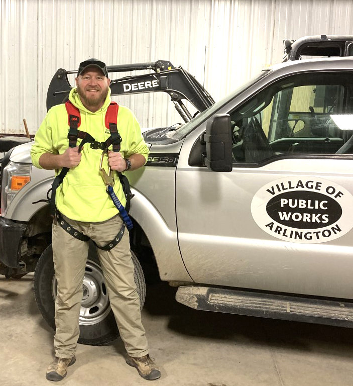 Tyler Fickenscher, Village of Arlington maintenance worker, wears a safety harness purchased through the Lean on LARM safety grant.