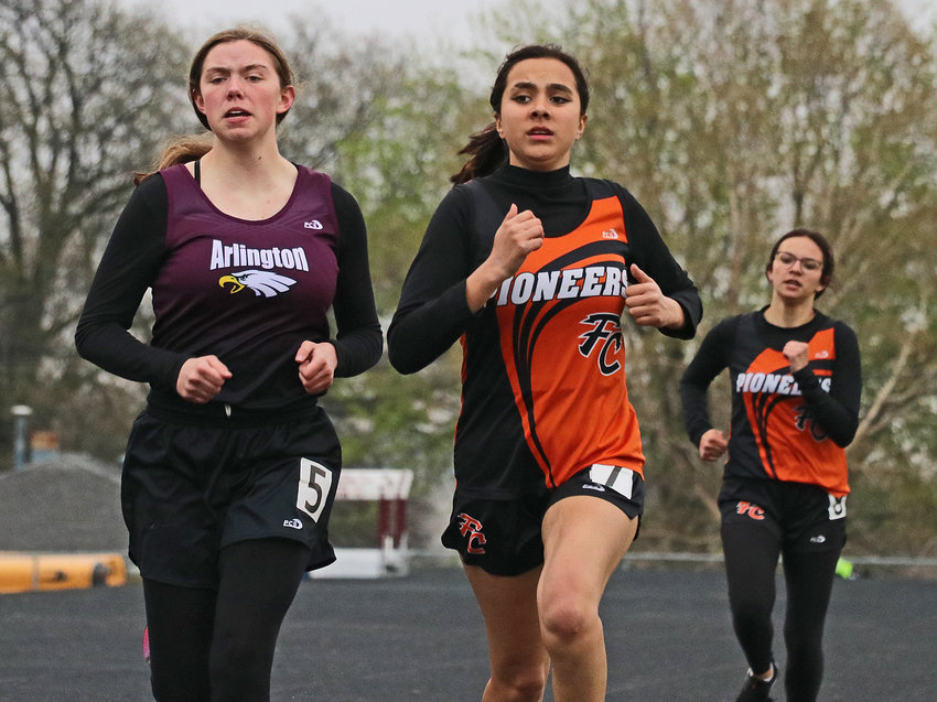 The Eagles' April Klein, from left, Fort Calhoun's Annie Scott and Natalie Reichert race to the finish line of the 800-meter run Thursday at Arlington High School.