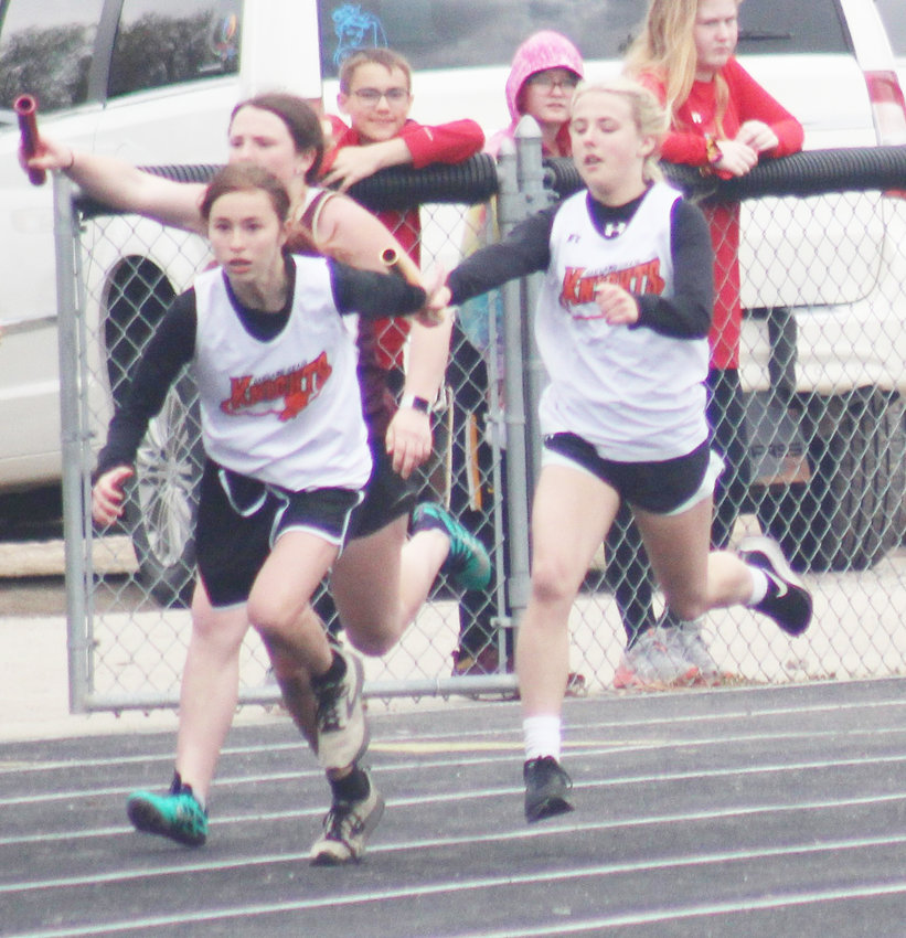 Jalyn Lane hands the baton off to Abigail Sechler during the 8th Grade 4x100 Relay at the EHC meet.