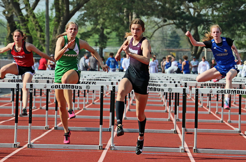 Arlington senior Kailynn Gubbels, middle, races to the finish line Tuesday in Columbus.